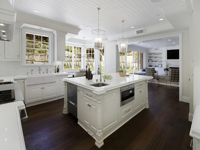 White Kitchen Countertops With Dark, Black Hardwood Floors In Kitchen